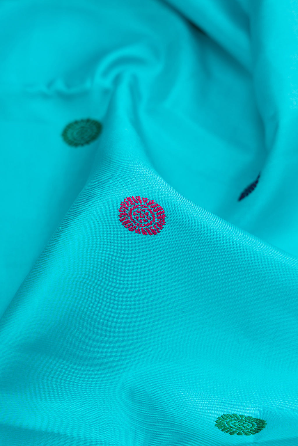 Close up of Sky Blue Dual Tone Kanchipuram Silk Saree with Thread Butta on the body and Zari Border.  displaying folds