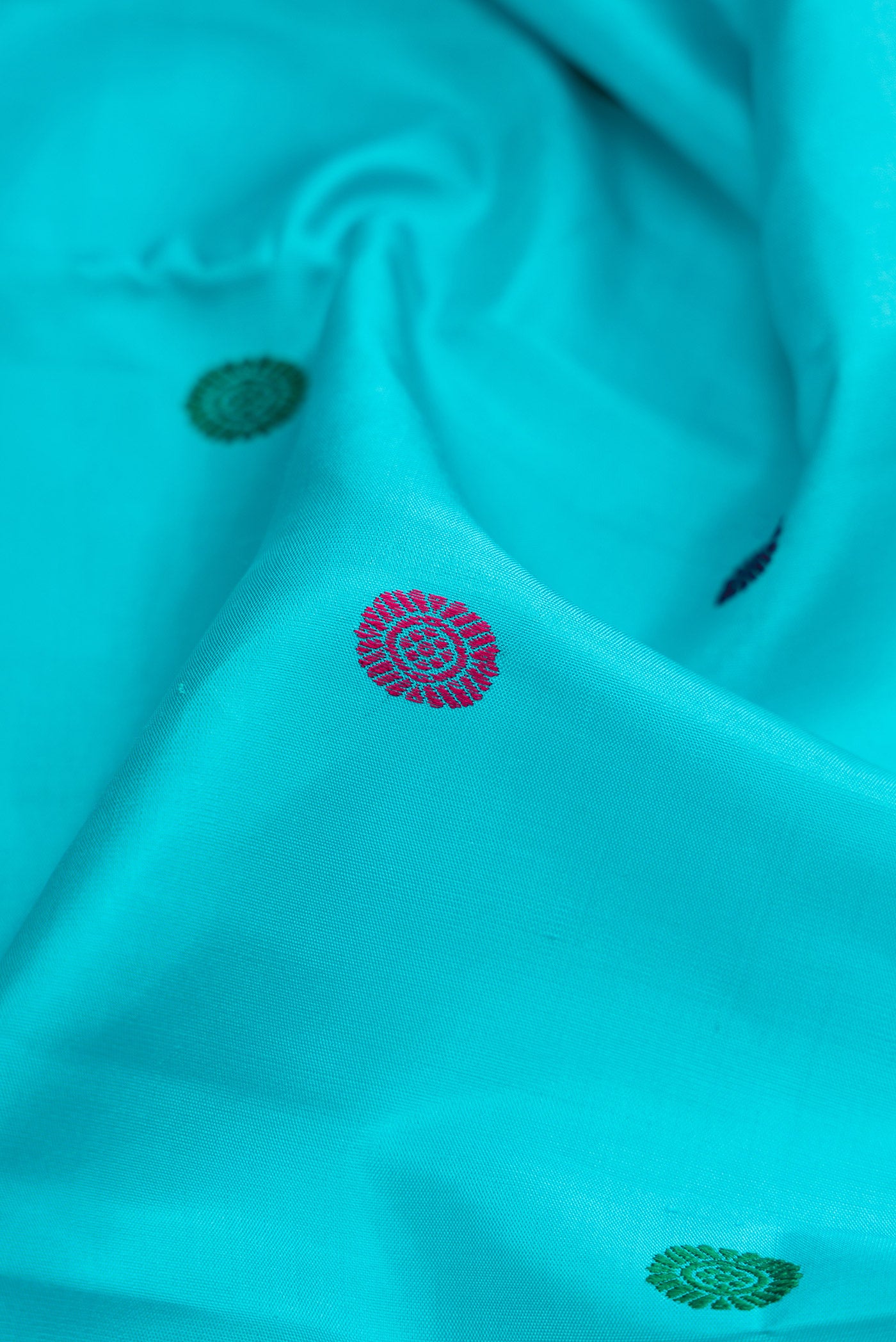 Close up of Sky Blue Dual Tone Kanchipuram Silk Saree with Thread Butta on the body and Zari Border.  displaying folds
