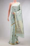 Pista Green Kanchipuram Silk Saree with Thread Butta on the body and Zari Border.  displayed on a mannequin