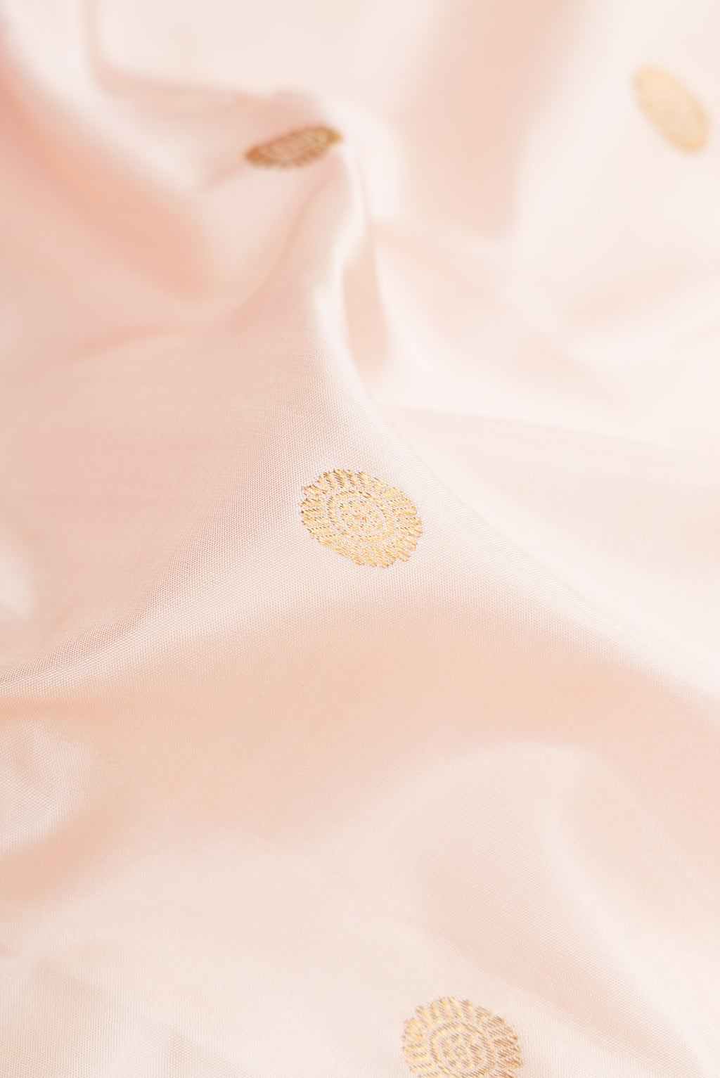 Close up of Sandal Kanchipuram Silk Saree with Zari Butta on the body and Zari Border.  displaying folds