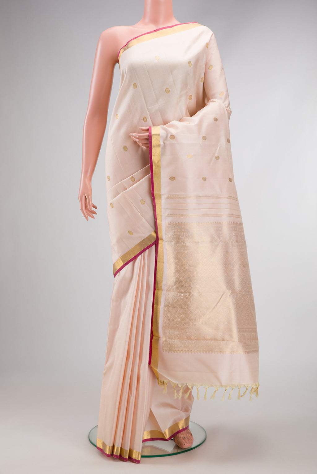 Sandal Kanchipuram Silk Saree with Zari Butta on the body and Zari Border.  displayed on a mannequin