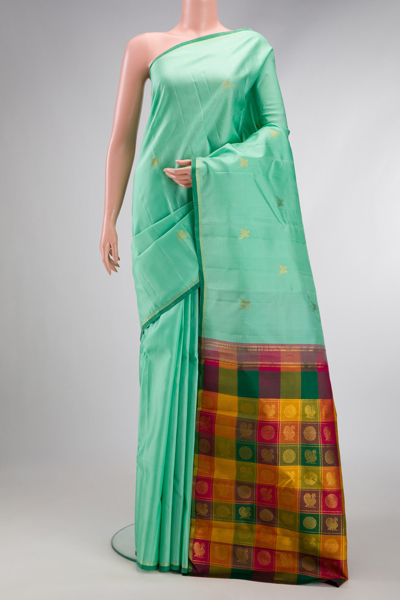 Sea Green Dual Tone Kanchipuram Silk Saree with Zari Butta on the body and Thin Zari Line.  displayed on a mannequin