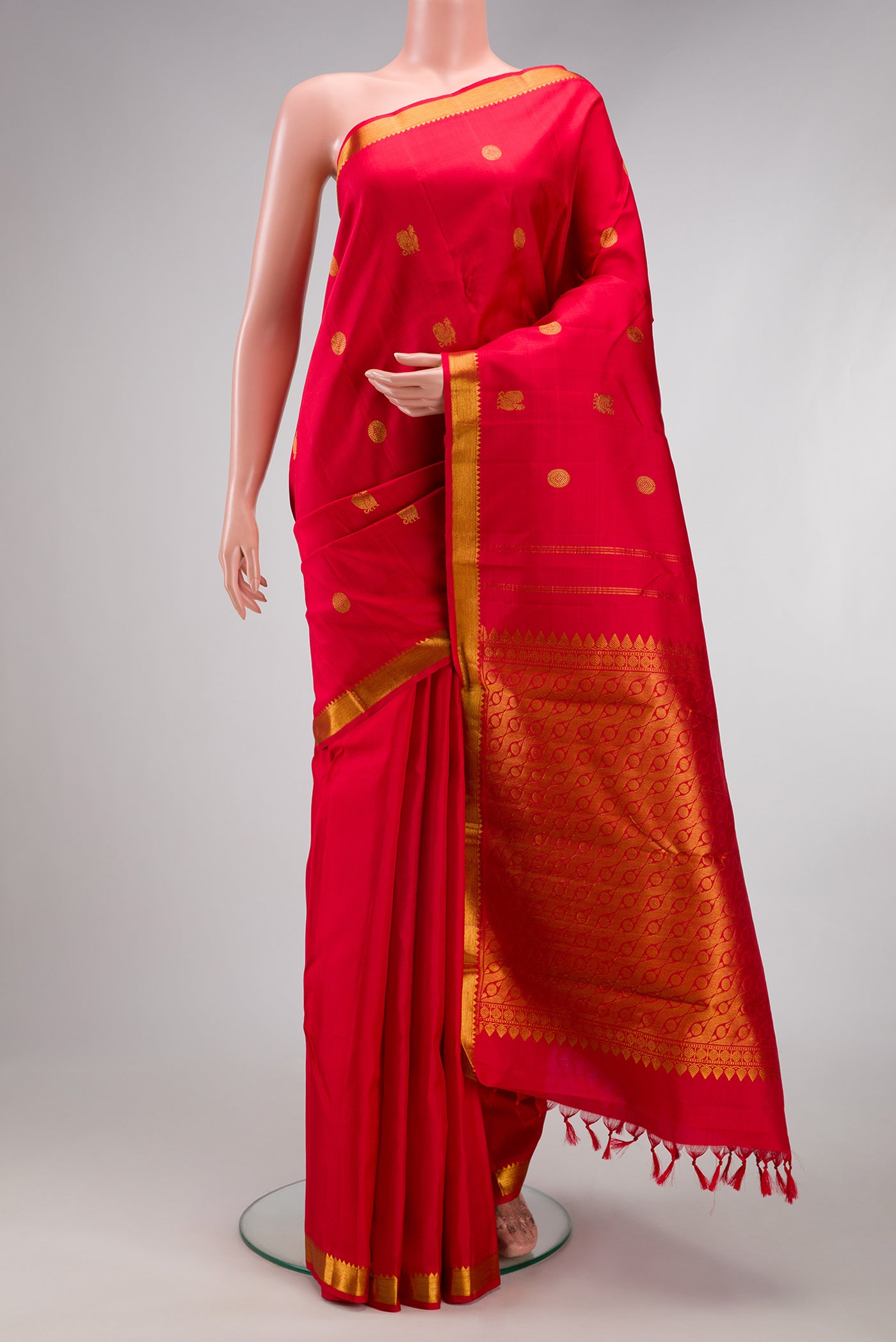 Red Kanchipuram Silk Saree with Zari Butta on the body and Zari Border.  displayed on a mannequin