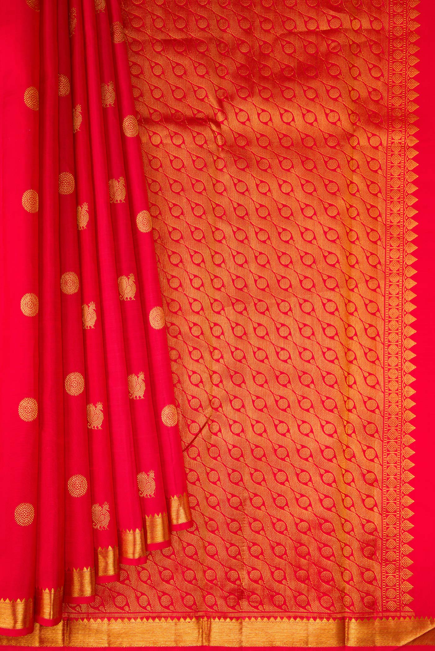 Pleats and pallu of Red Kanchipuram Silk Saree with Zari Butta on the body and Zari Border. 
