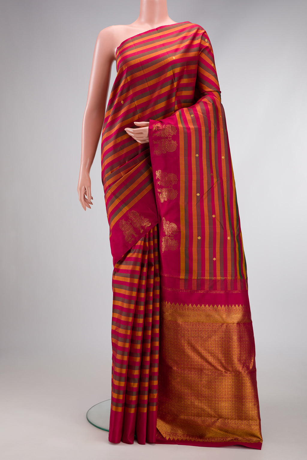Multi Color Kanchipuram Silk Saree with Stripes on the body and Fancy Border.  displayed on a mannequin