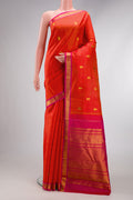 Coral Dual Tone Kanchipuram Silk Saree with Zari Butta on the body and Zari Border.  displayed on a mannequin