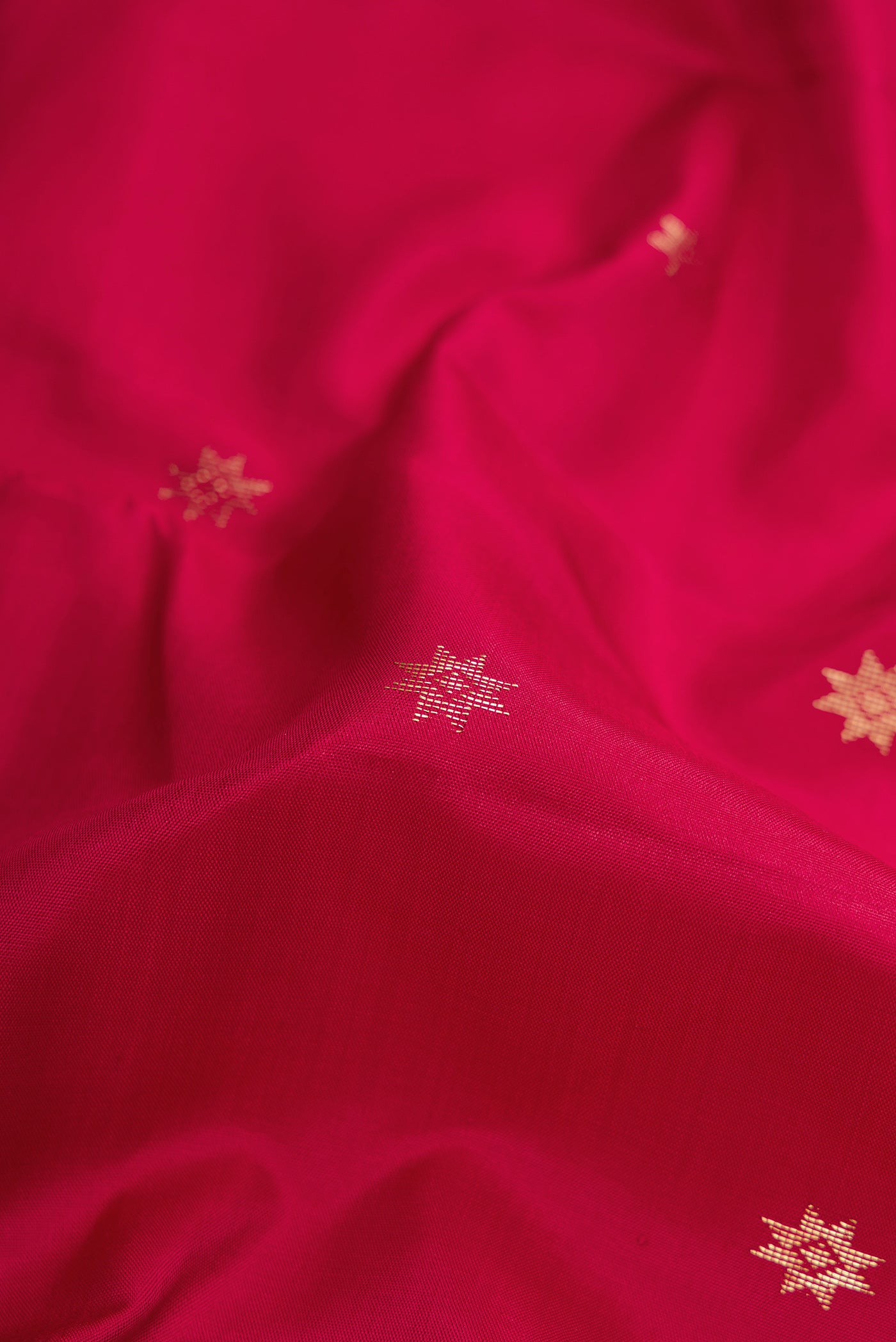 Close up of Maroon Dual Tone Kanchipuram Silk Saree with Zari Butta on the body and Zari Border.  displaying folds