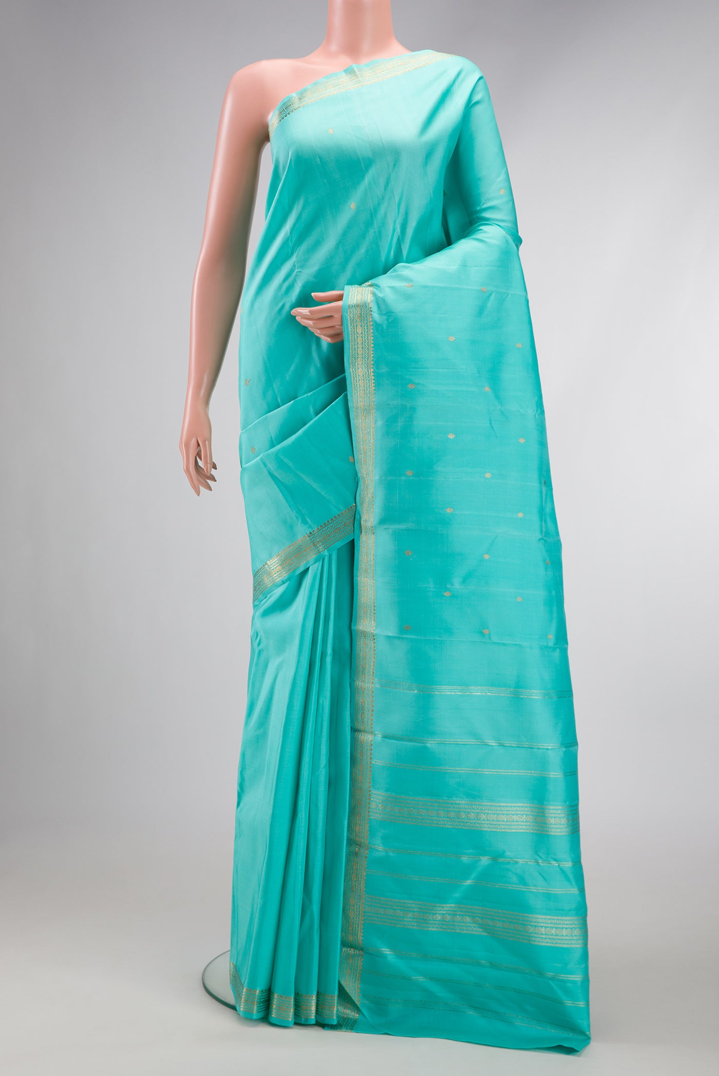Sky Blue Dual Tone Kanchipuram Silk Saree with Zari Butta on the body and Zari Border.  displayed on a mannequin