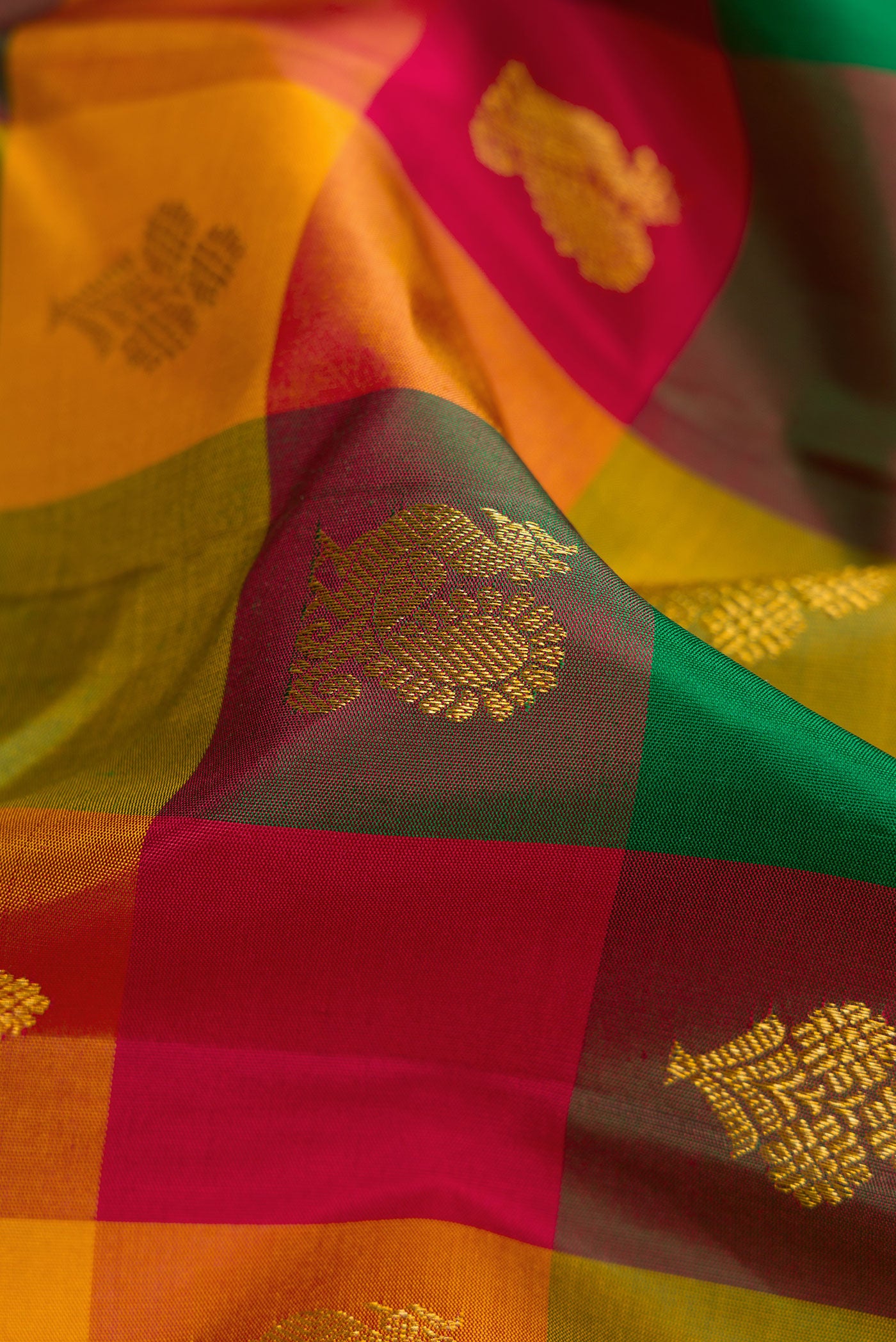 Close up of Multi Color Kanchipuram Silk Saree with Checked design on the body and Zari Border.  displaying folds