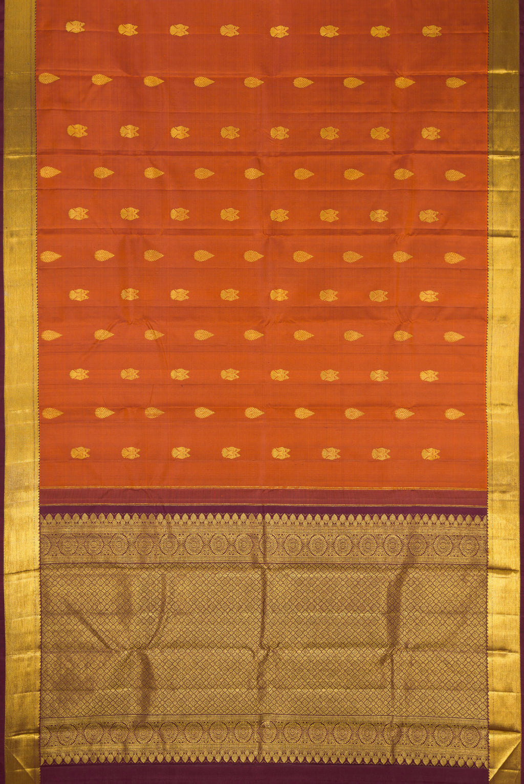 Flat view of Brick Orange Dual Tone Kanjivaram Silk Saree with Zari Butta on the body and Zari Border. 