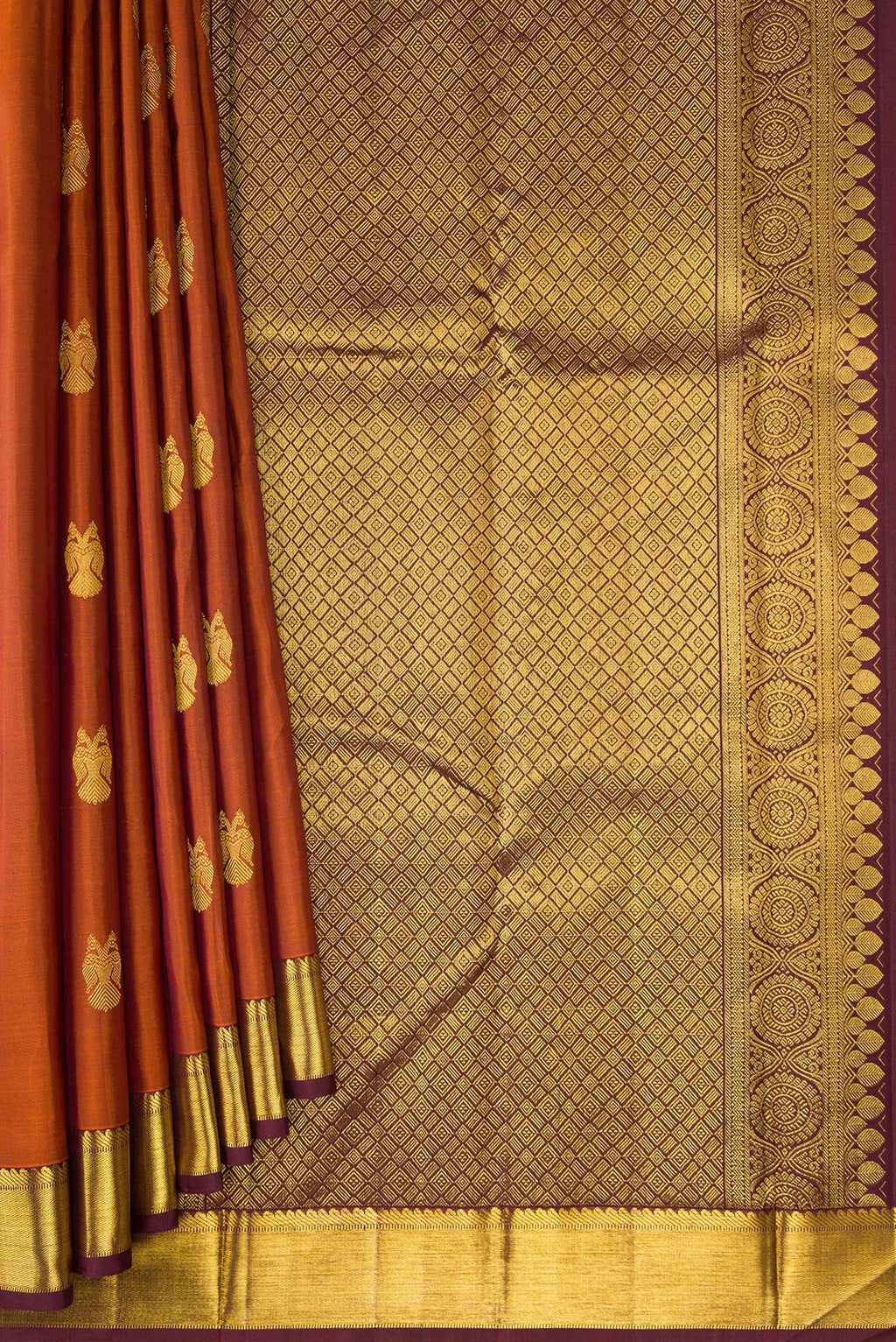 Pleats and pallu of Brick Orange Dual Tone Kanjivaram Silk Saree with Zari Butta on the body and Zari Border. 