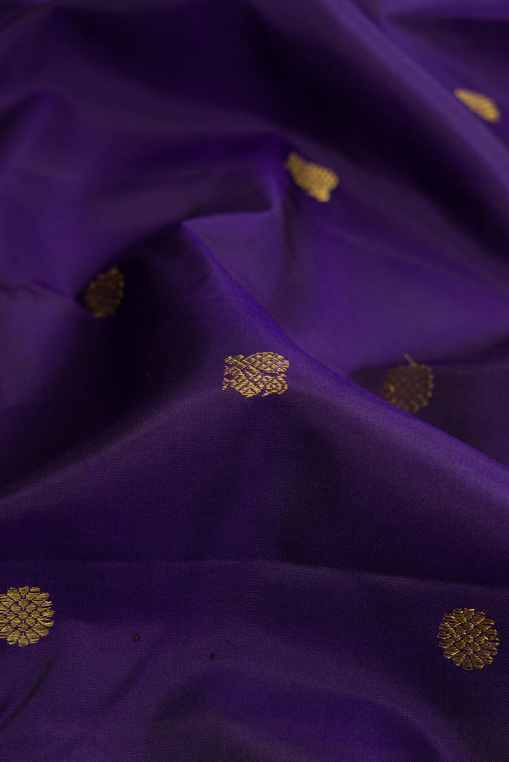 Close up of Navy Blue Kanjivaram Silk Saree with Zari Butta on the body and Zari And Thread Border.  displaying folds
