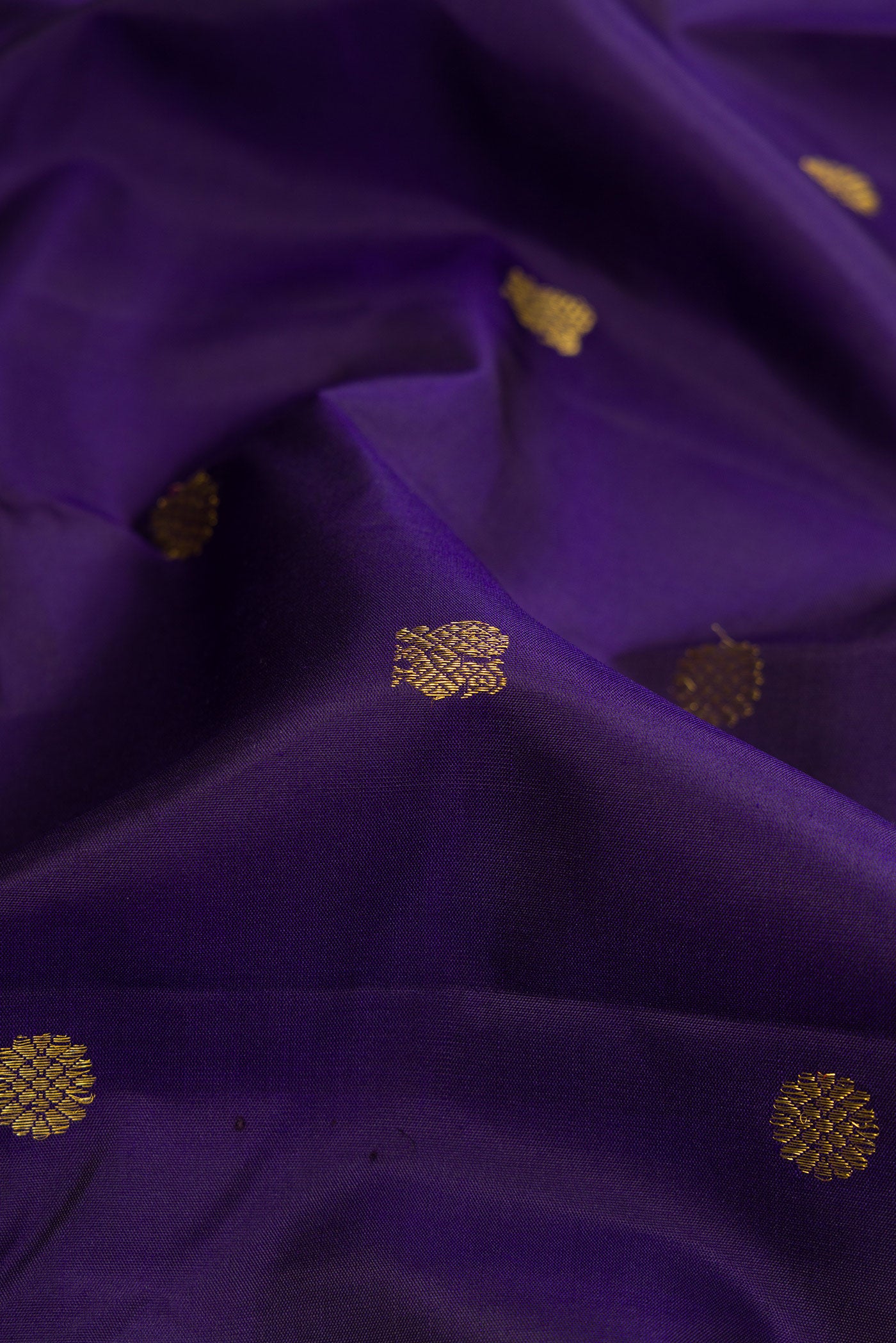Close up of Navy Blue Kanjivaram Silk Saree with Zari Butta on the body and Zari And Thread Border.  displaying folds