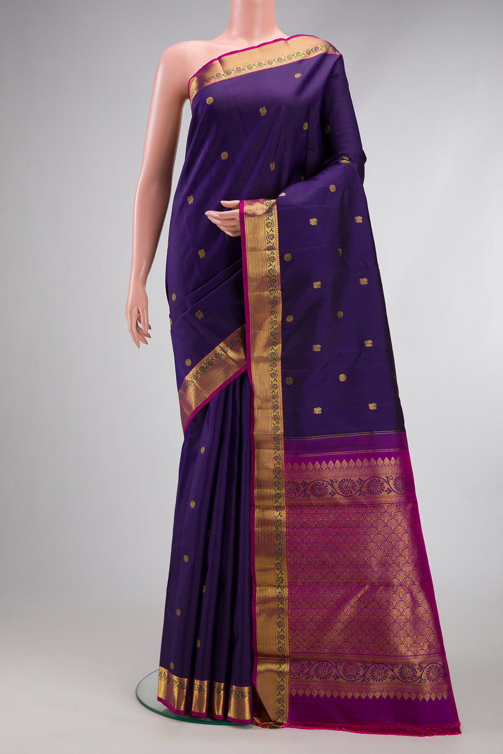 Navy Blue Kanjivaram Silk Saree with Zari Butta on the body and Zari And Thread Border.  displayed on a mannequin