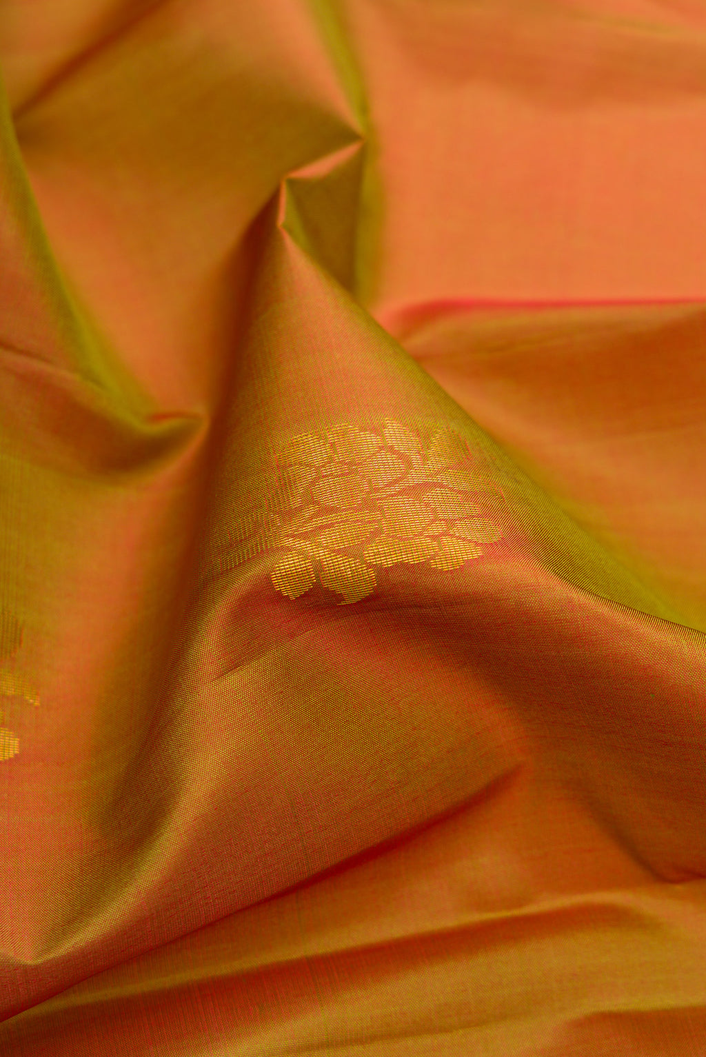 Close up of Mehandi Green Dual Tone Soft Silk Saree with Zari Butta on the body and Fancy Border.  displaying folds