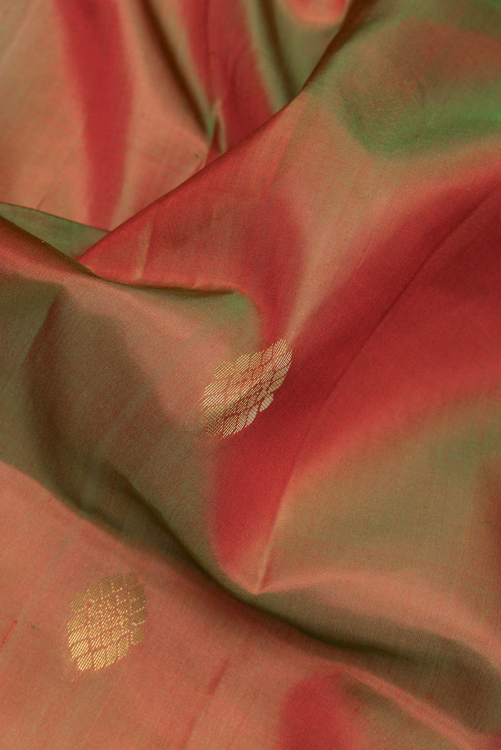 Close up of Mehandi Green Dual Tone Soft Silk Saree with Zari Butta on the body and Fancy Border.  displaying folds