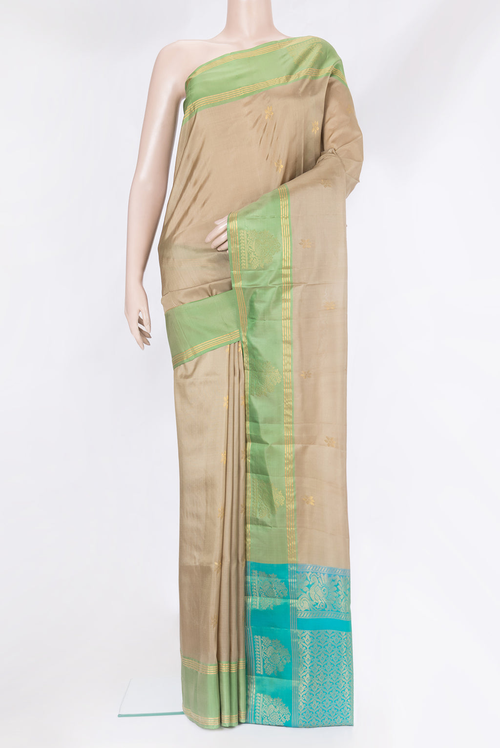 Dark Beige Soft Silk Saree with Zari Butta on the body and Fancy Border.  displayed on a mannequin