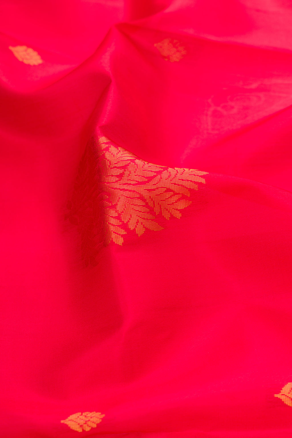 Close up of Pink Soft Silk Saree with Zari Butta on the body and Fancy Border.  displaying folds