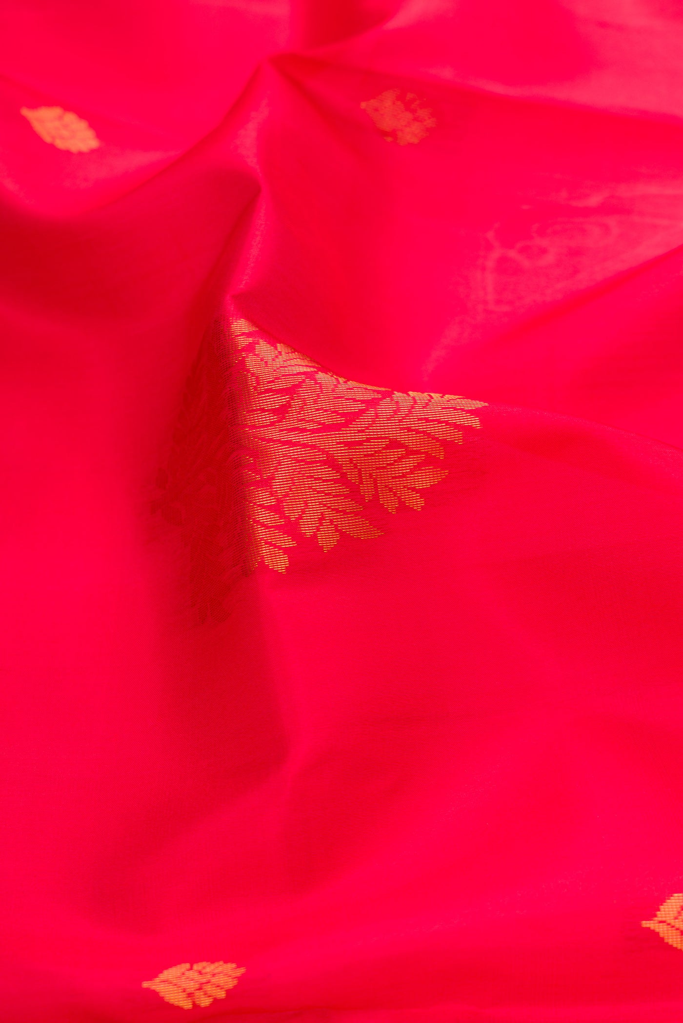 Close up of Pink Soft Silk Saree with Zari Butta on the body and Fancy Border.  displaying folds