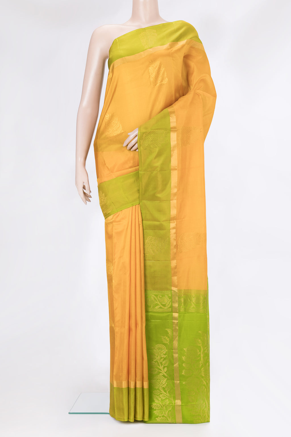 Mustard Soft Silk Saree with Zari Butta on the body and Zari Border.  displayed on a mannequin
