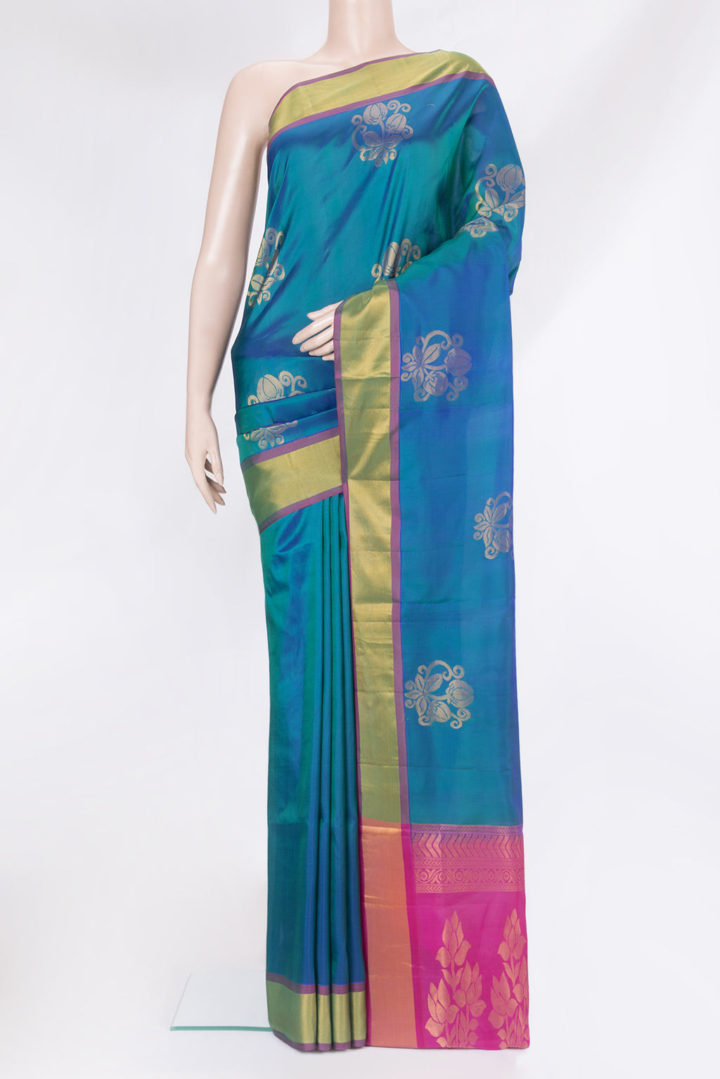 Peacock Blue Soft Silk Saree with Zari Butta on the body and Zari Border.  displayed on a mannequin