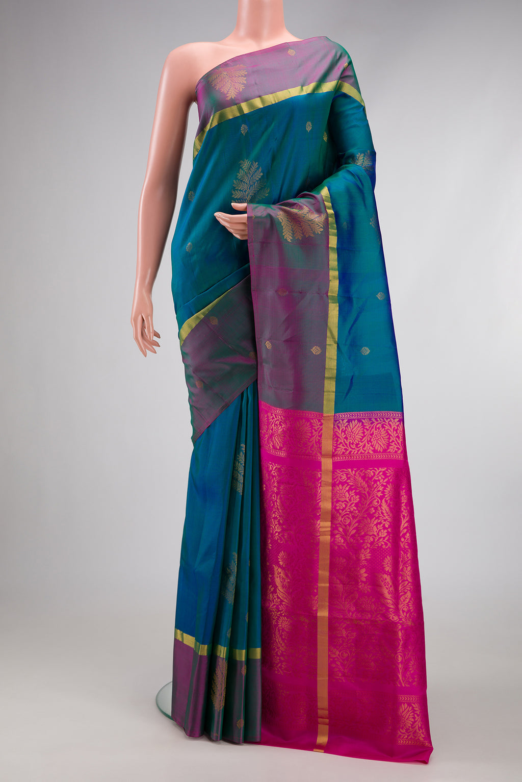 Peacock Blue Dual Tone Soft Silk Saree with Zari Butta on the body and Fancy Border.  displayed on a mannequin