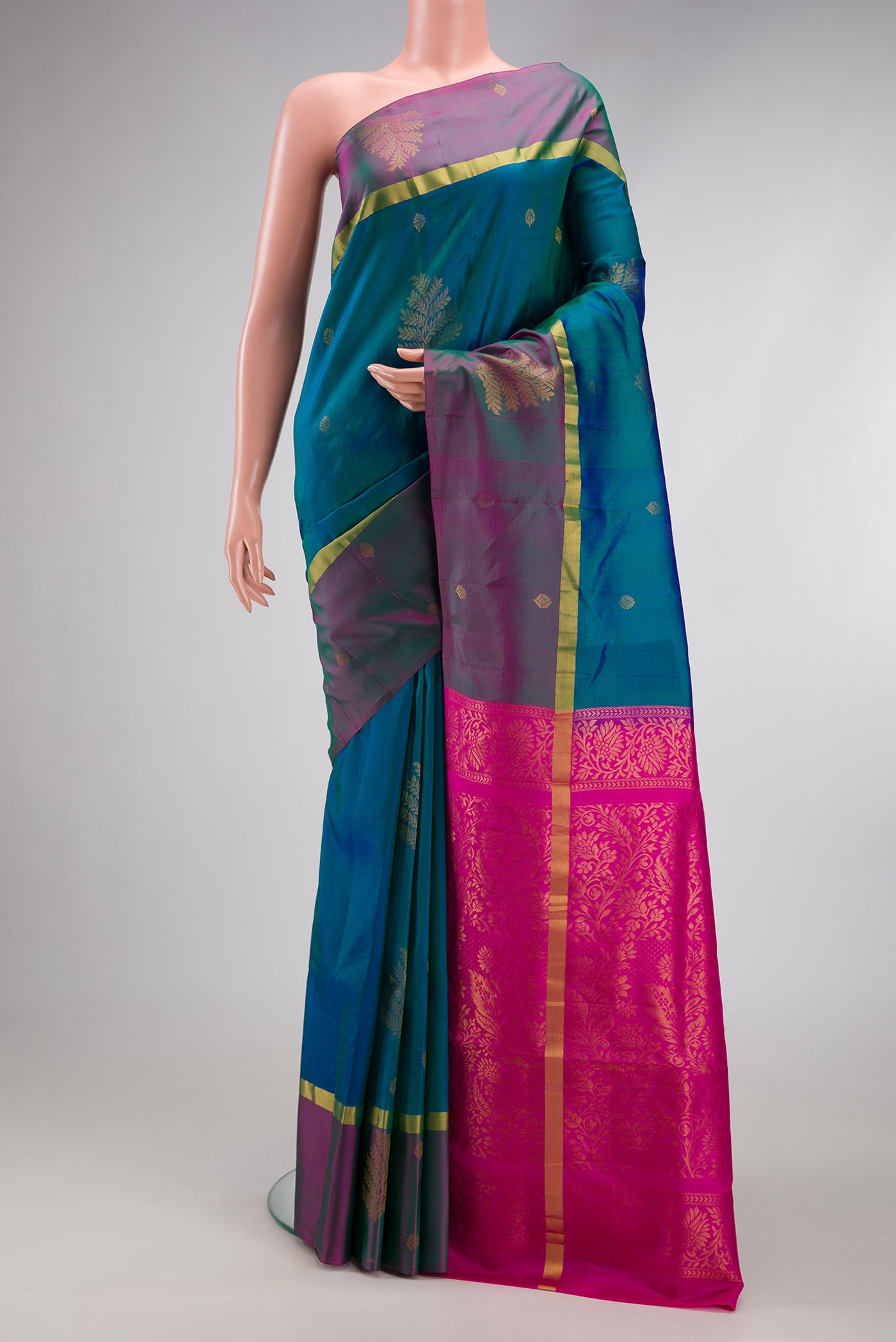 Peacock Blue Dual Tone Soft Silk Saree with Zari Butta on the body and Fancy Border.  displayed on a mannequin