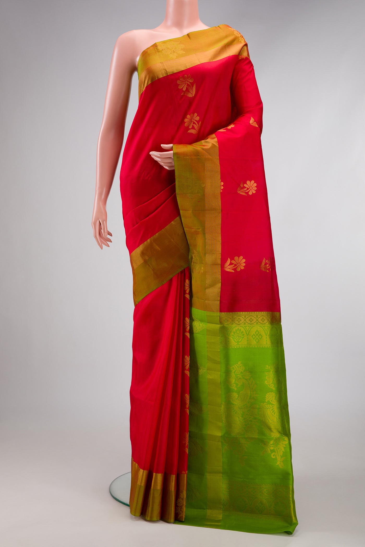 Red Soft Silk Saree with Zari Butta on the body and Fancy Border.  displayed on a mannequin