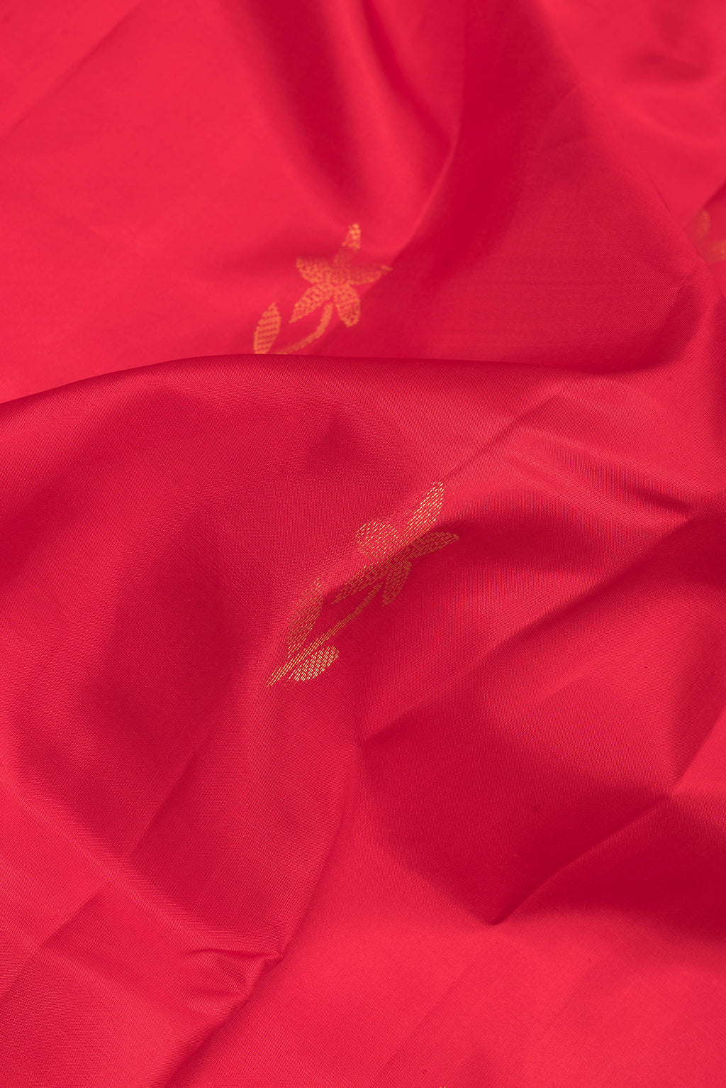 Close up of Red Soft Silk Saree with Zari Butta on the body and Zari Border.  displaying folds