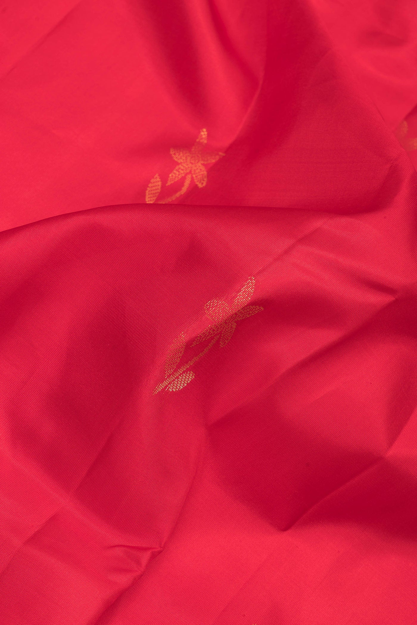 Close up of Red Soft Silk Saree with Zari Butta on the body and Zari Border.  displaying folds