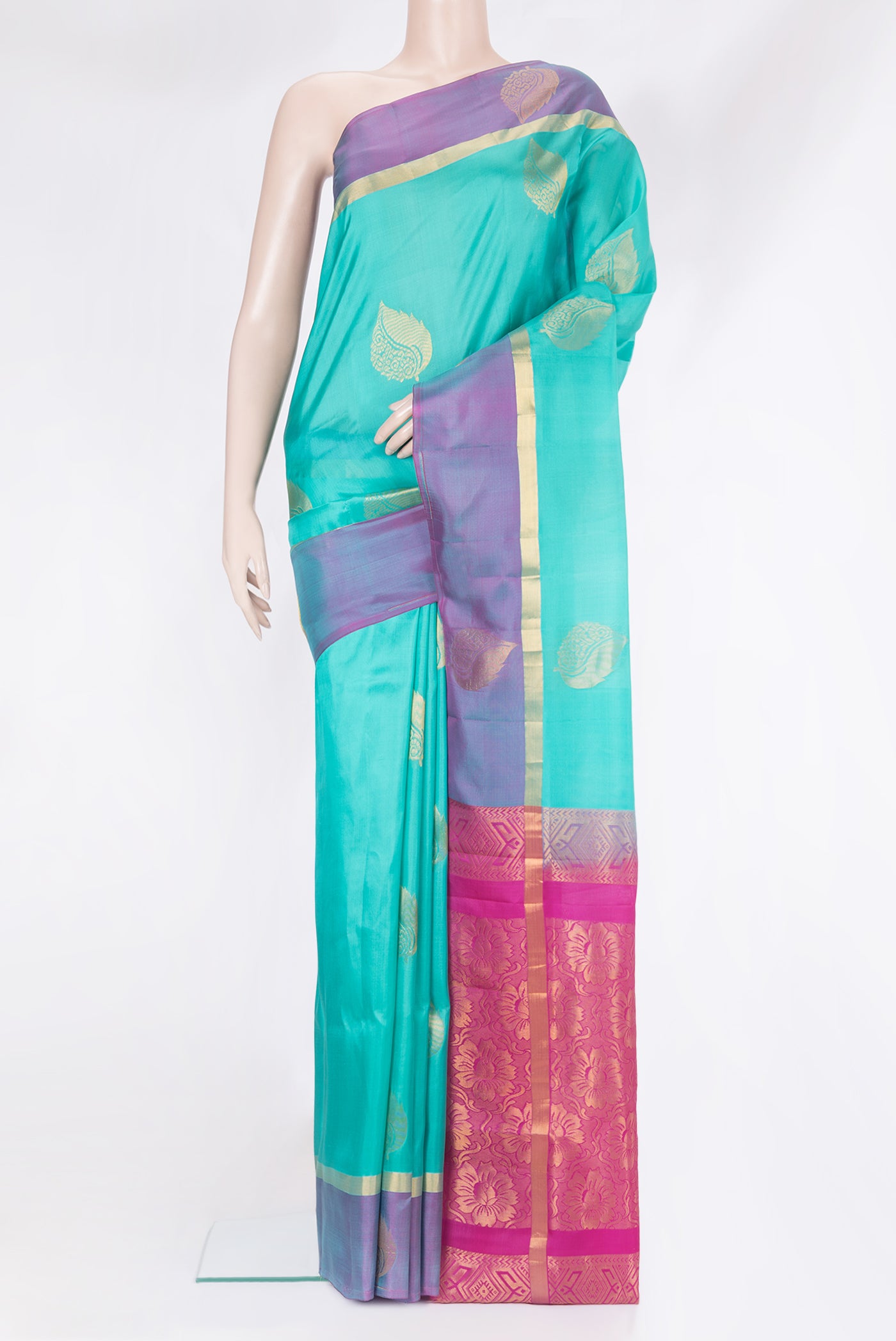 Sky Blue Soft Silk Saree with Zari Butta on the body and Fancy Border.  displayed on a mannequin