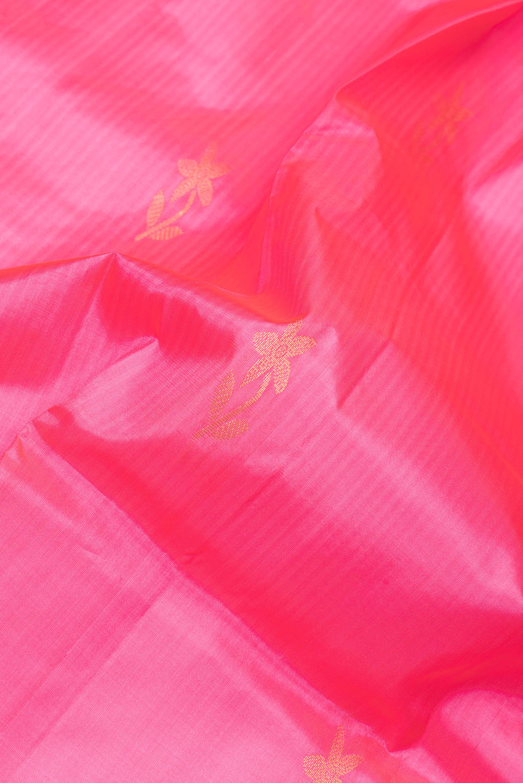 Close up of Pink Soft Silk Saree with Zari Butta on the body and Plain Border.  displaying folds