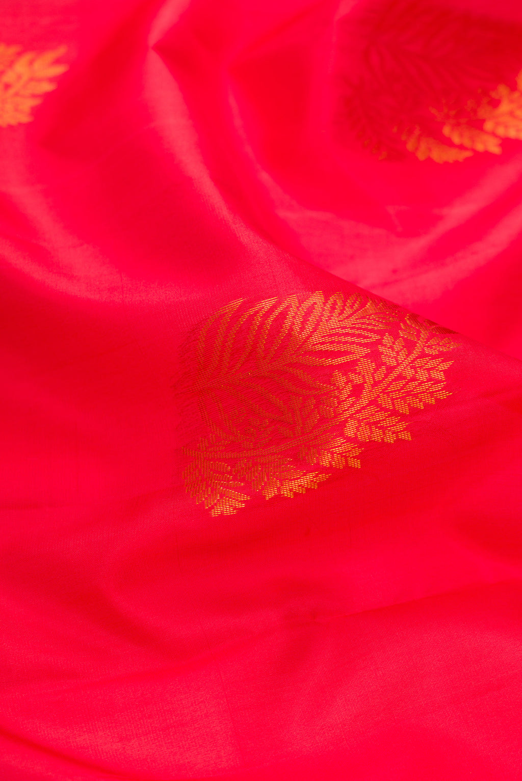 Close up of Pink Soft Silk Saree with Zari Butta on the body and Fancy Border.  displaying folds