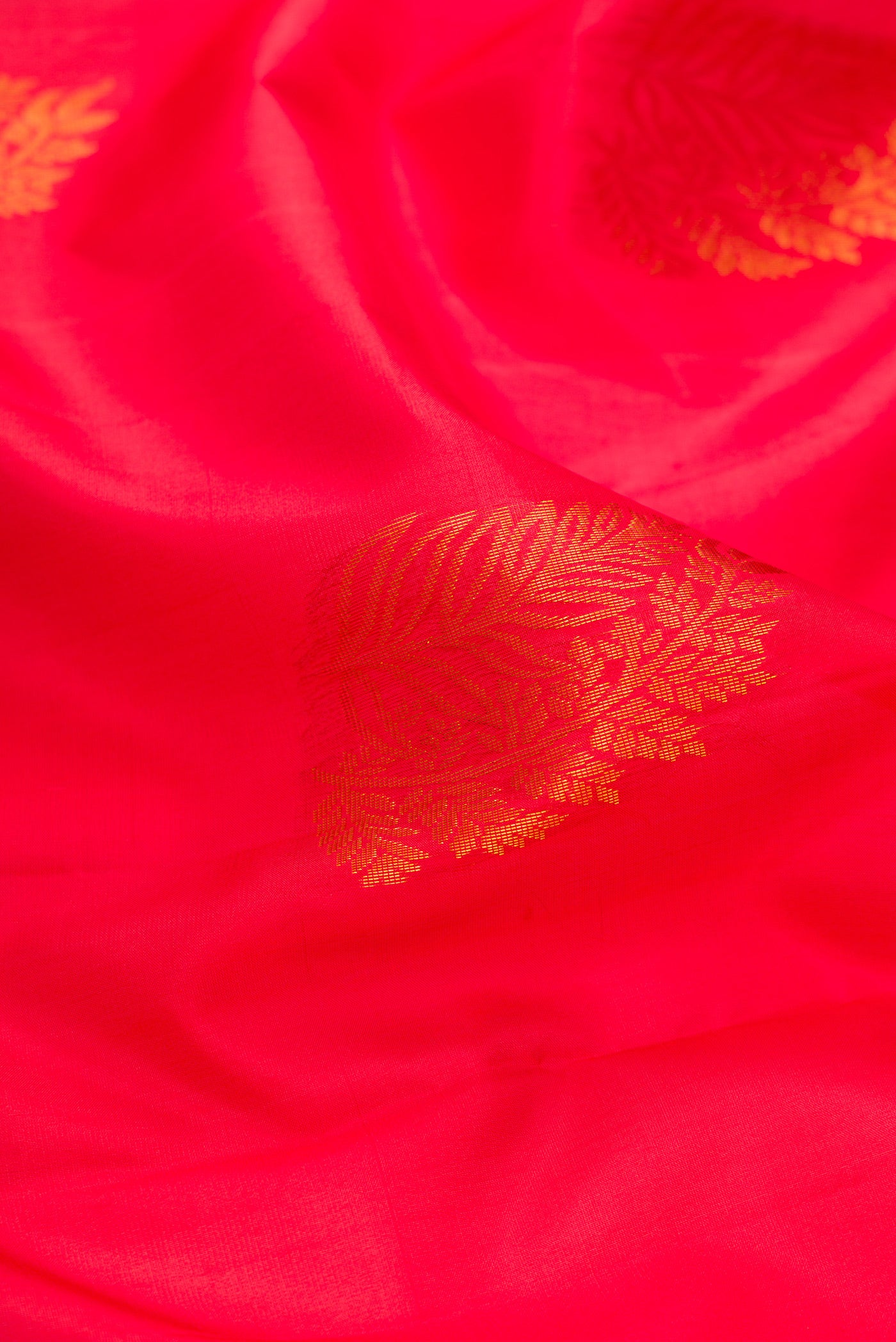 Close up of Pink Soft Silk Saree with Zari Butta on the body and Fancy Border.  displaying folds