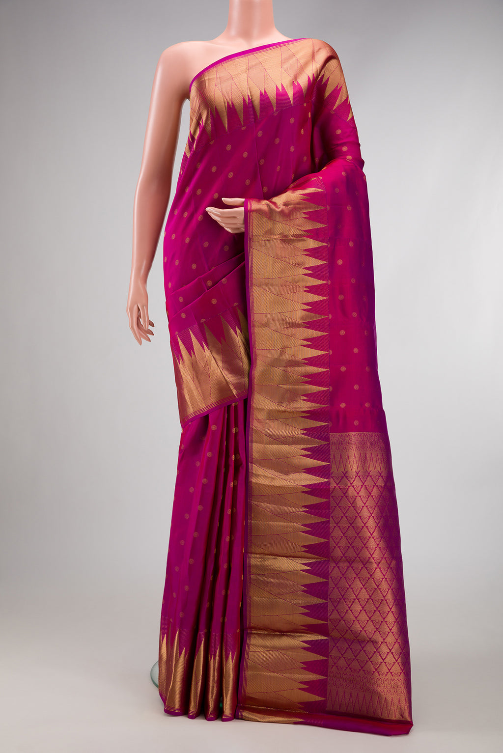 Magenta Kanchipuram Silk Saree with Zari Butta on the body and Temple Border.  displayed on a mannequin