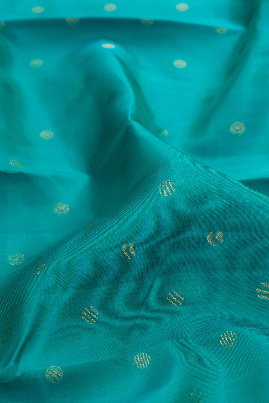 Close up of Sea Green Kanchipuram Silk Saree with Zari Butta on the body and Fancy Border.  displaying folds
