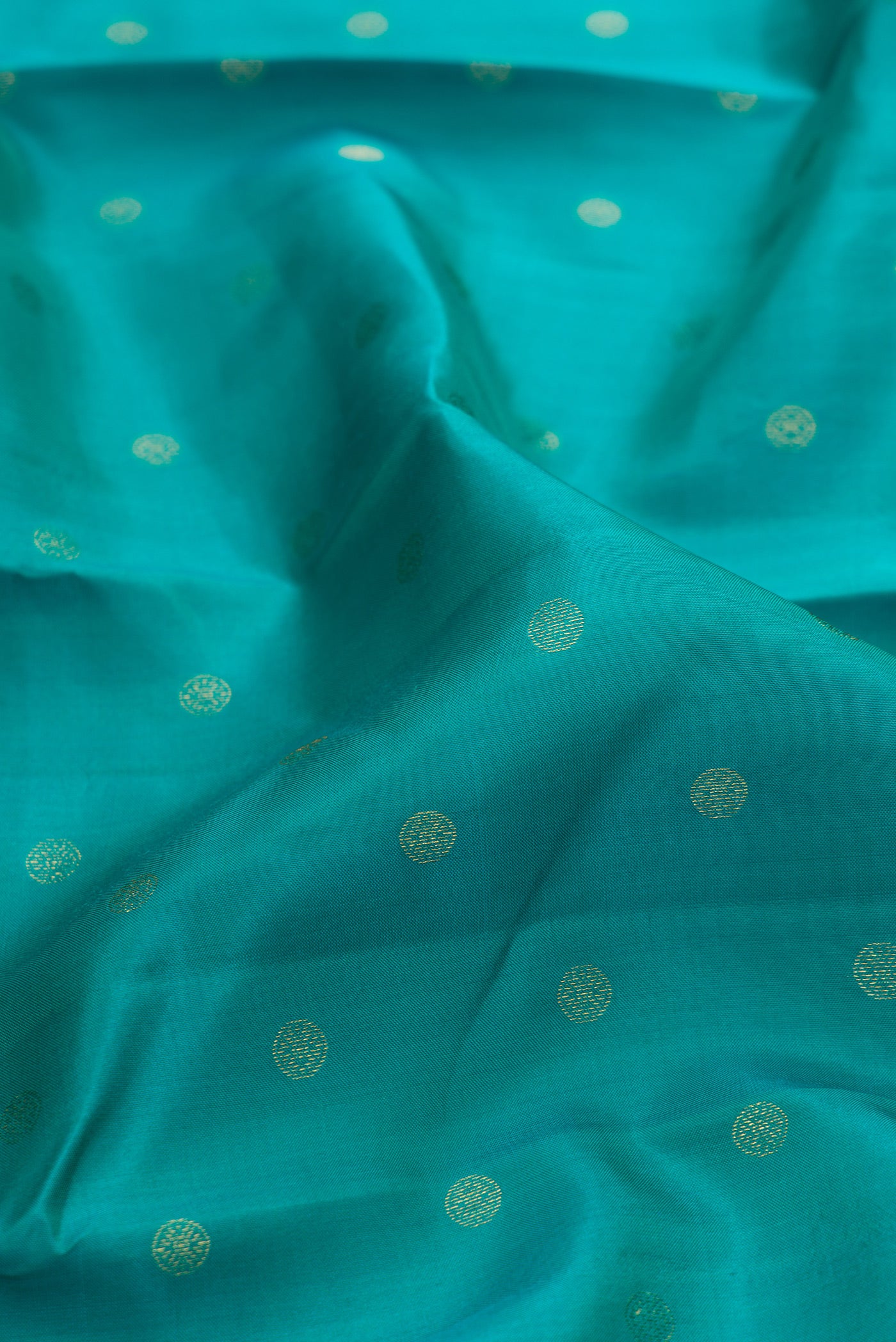 Close up of Sea Green Kanchipuram Silk Saree with Zari Butta on the body and Fancy Border.  displaying folds