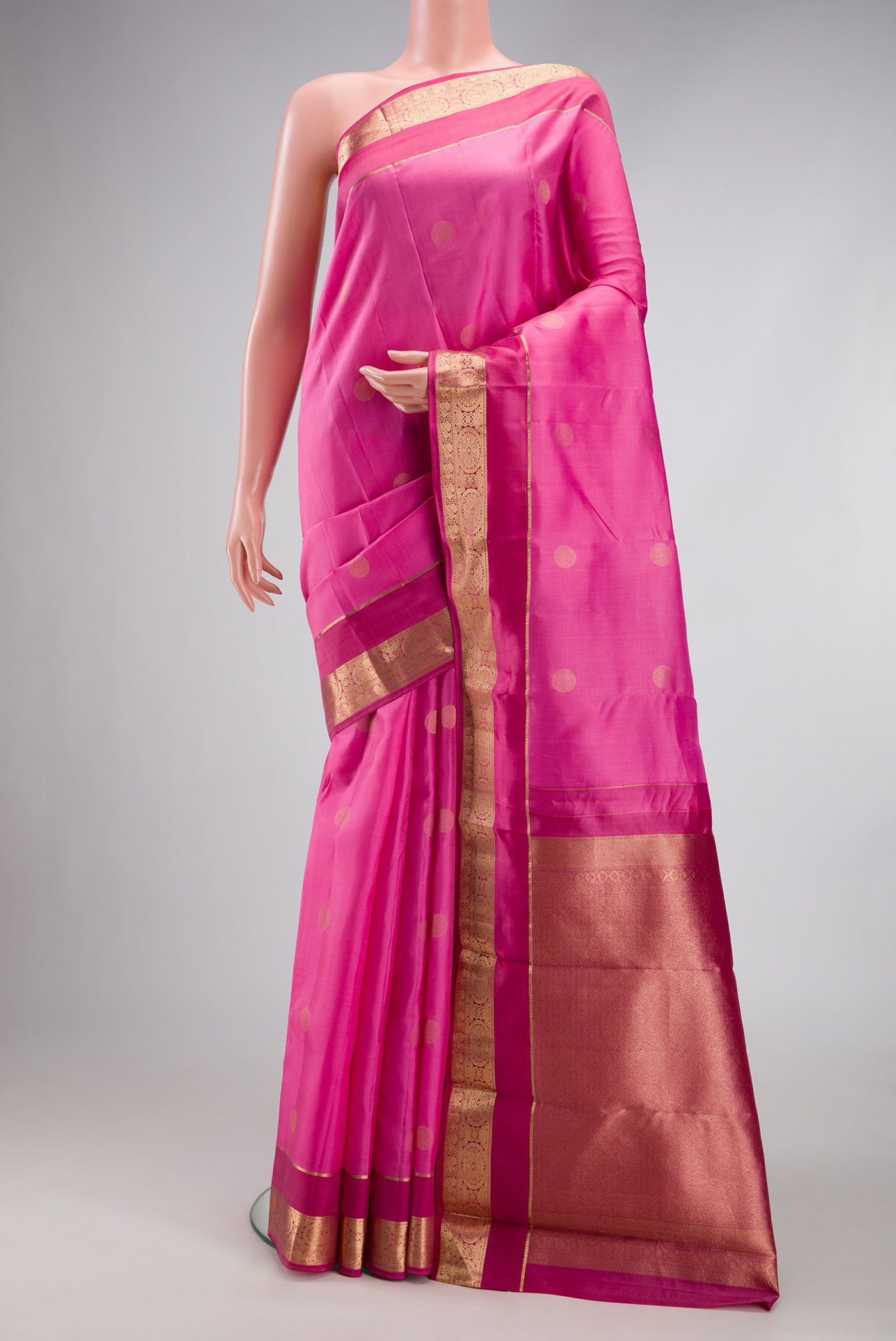 Rose Gold Kanchipuram Silk Saree with Zari Butta on the body and Zari Border.  displayed on a mannequin