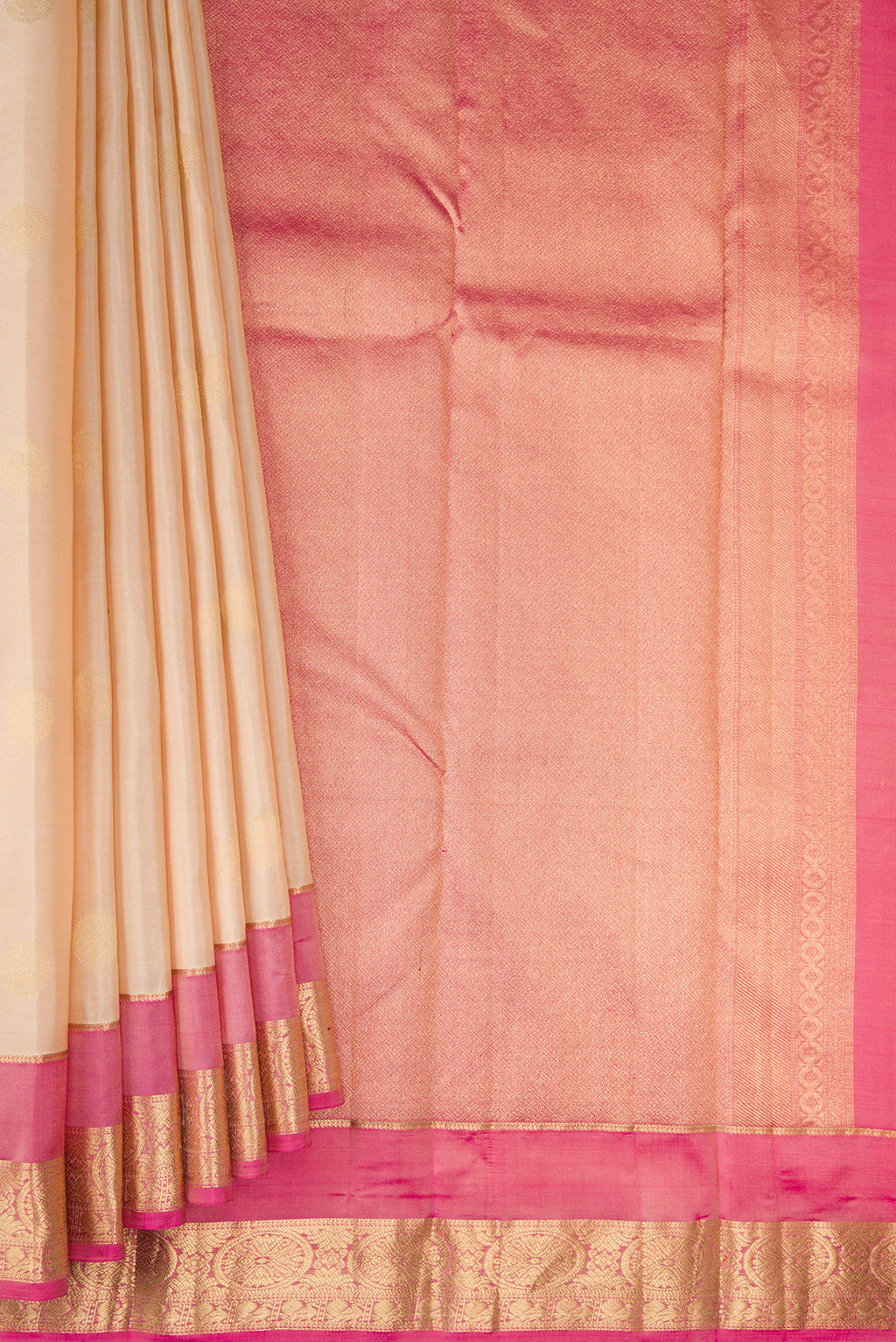 Pleats and pallu of Beige Kanchipuram Silk Saree with Zari Butta on the body and Zari Border. 