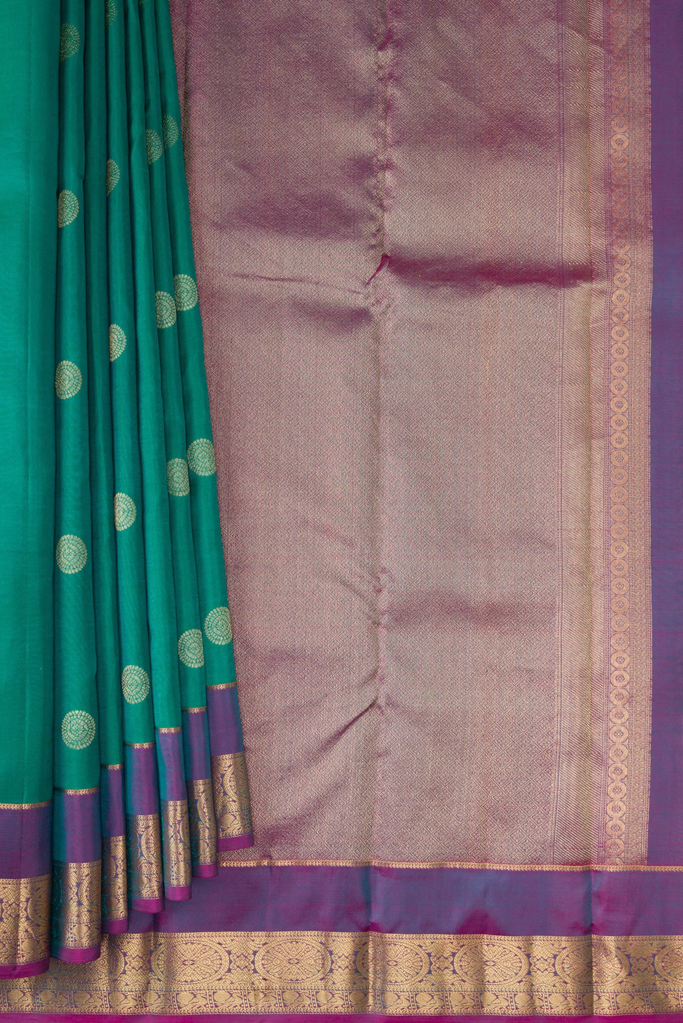 Pleats and pallu of Green Kanchipuram Silk Saree with Zari Butta on the body and Zari Border. 