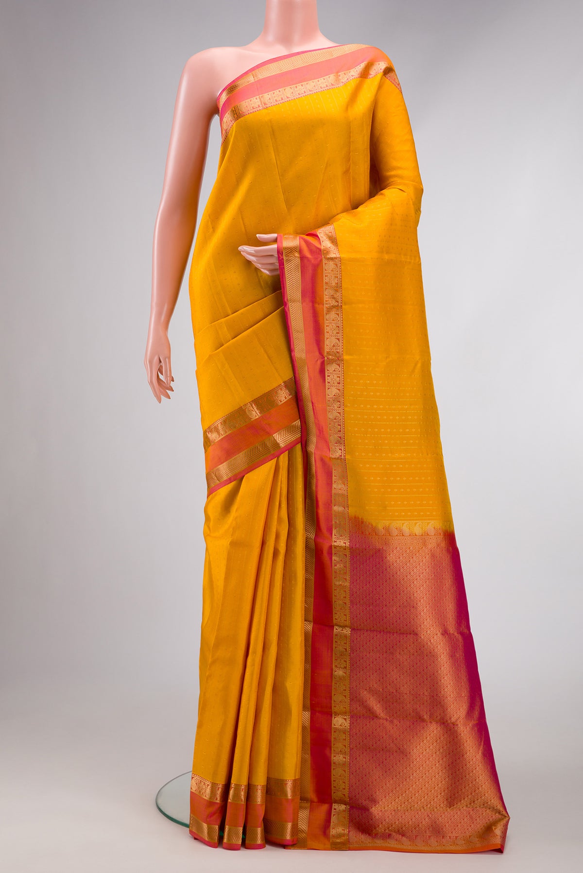 Yellow Dual Tone Kanchipuram Silk Saree with Zari Butta on the body and Zari Border.  displayed on a mannequin