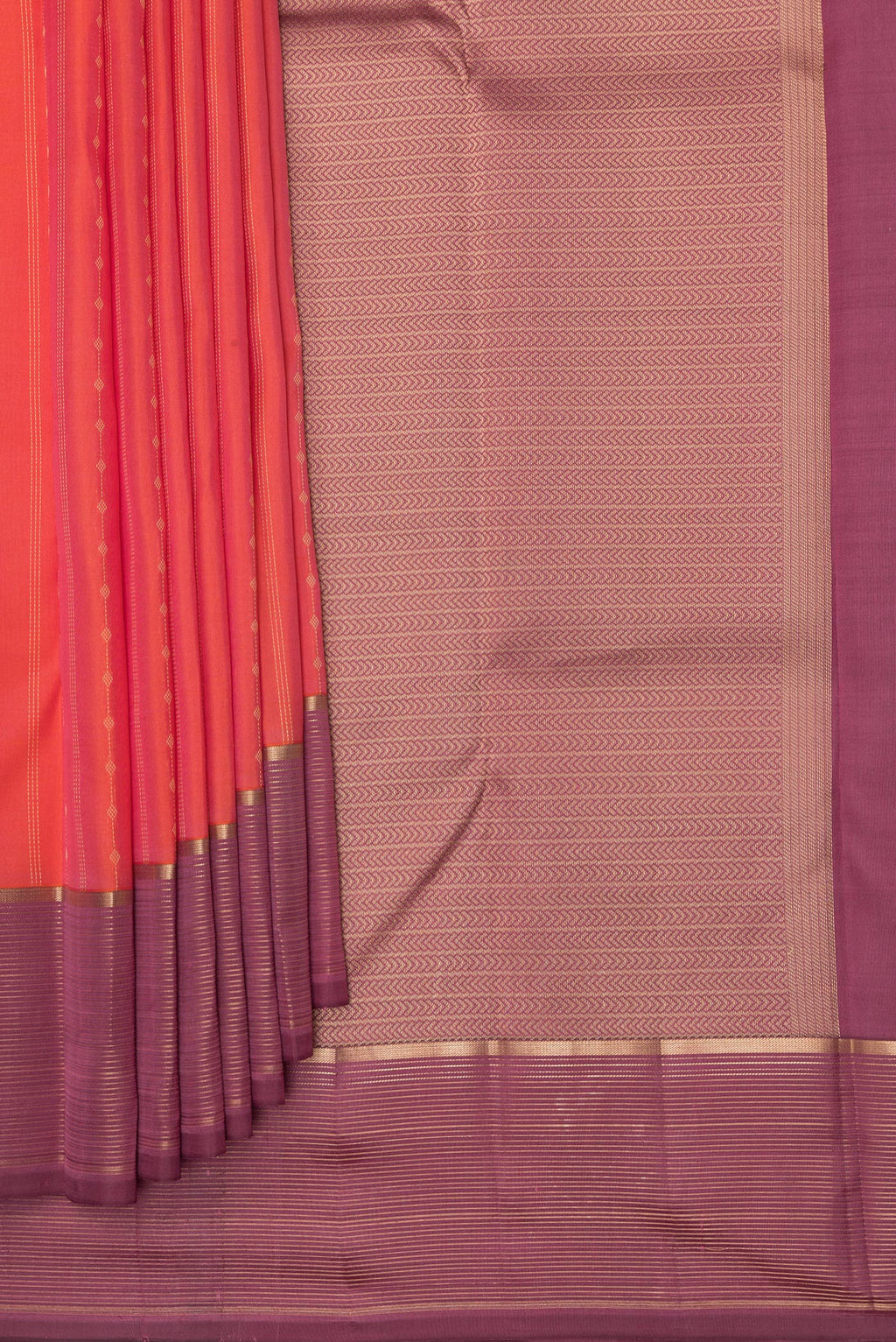 Pleats and pallu of Brick Orange Dual Tone Kanchipuram Silk Saree with Zari Butta on the body and Zari Border. 