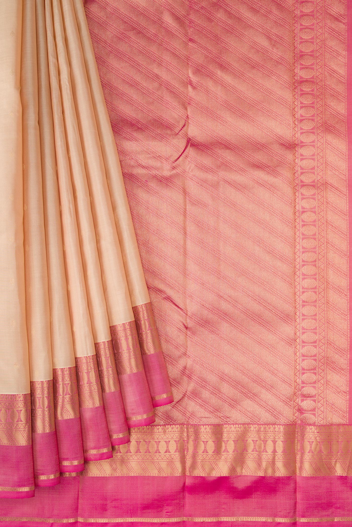 Pleats and pallu of Beige Kanchipuram Silk Saree with Zari Butta on the body and Zari Border. 