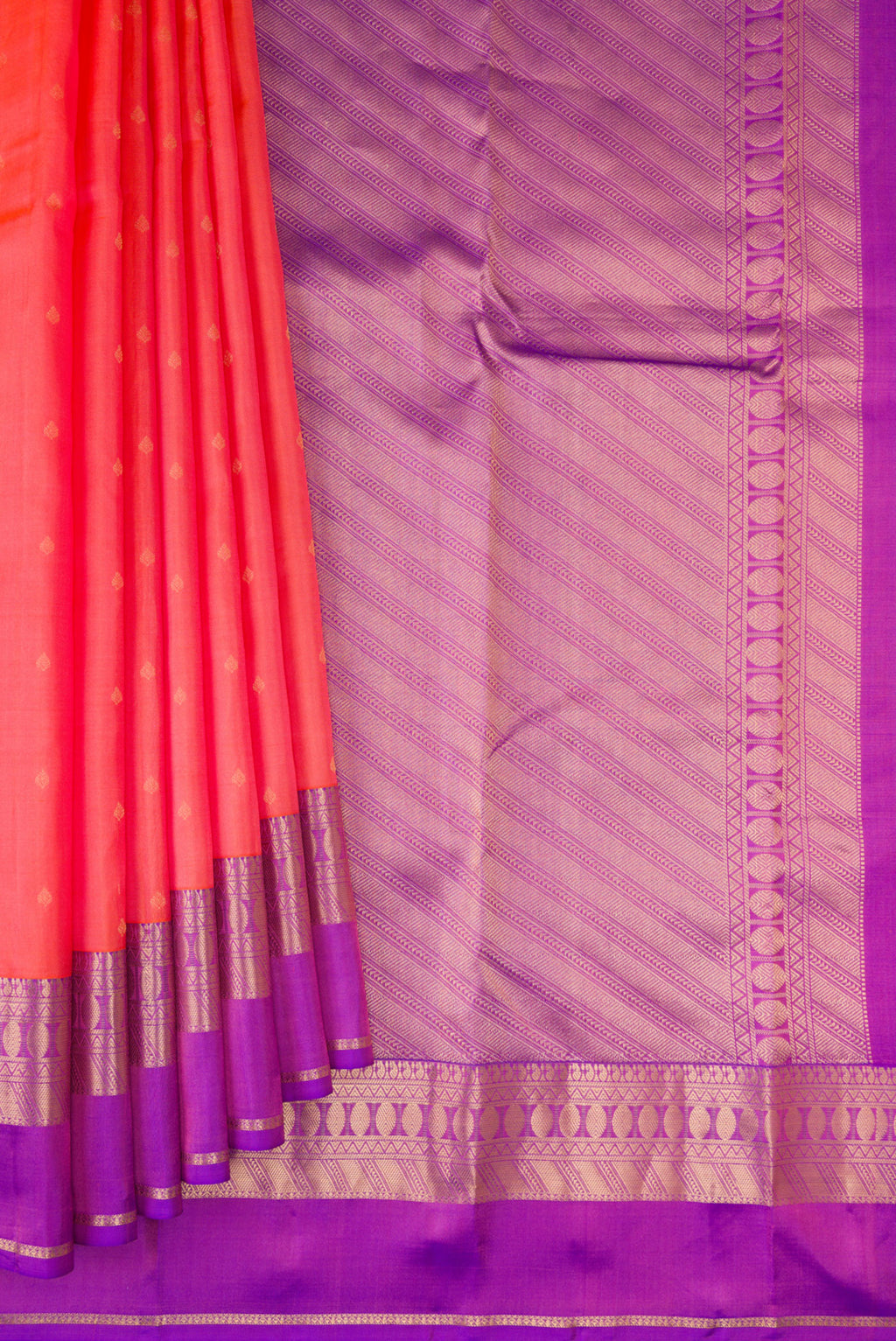 Pleats and pallu of Coral Kanchipuram Silk Saree with Zari Butta on the body and Zari Border. 