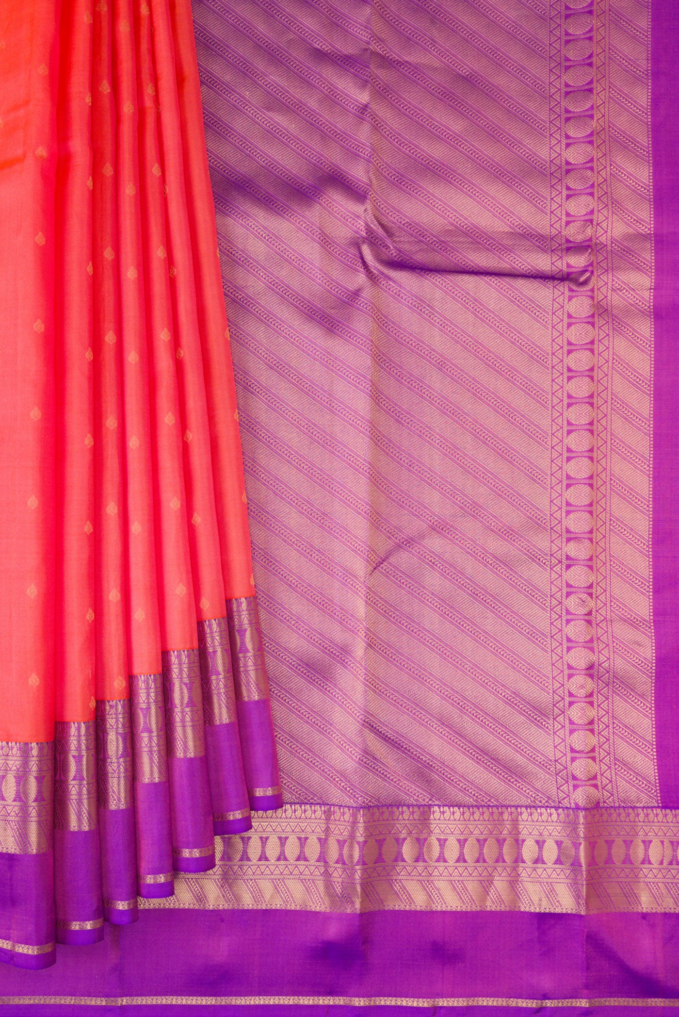 Pleats and pallu of Coral Kanchipuram Silk Saree with Zari Butta on the body and Zari Border. 