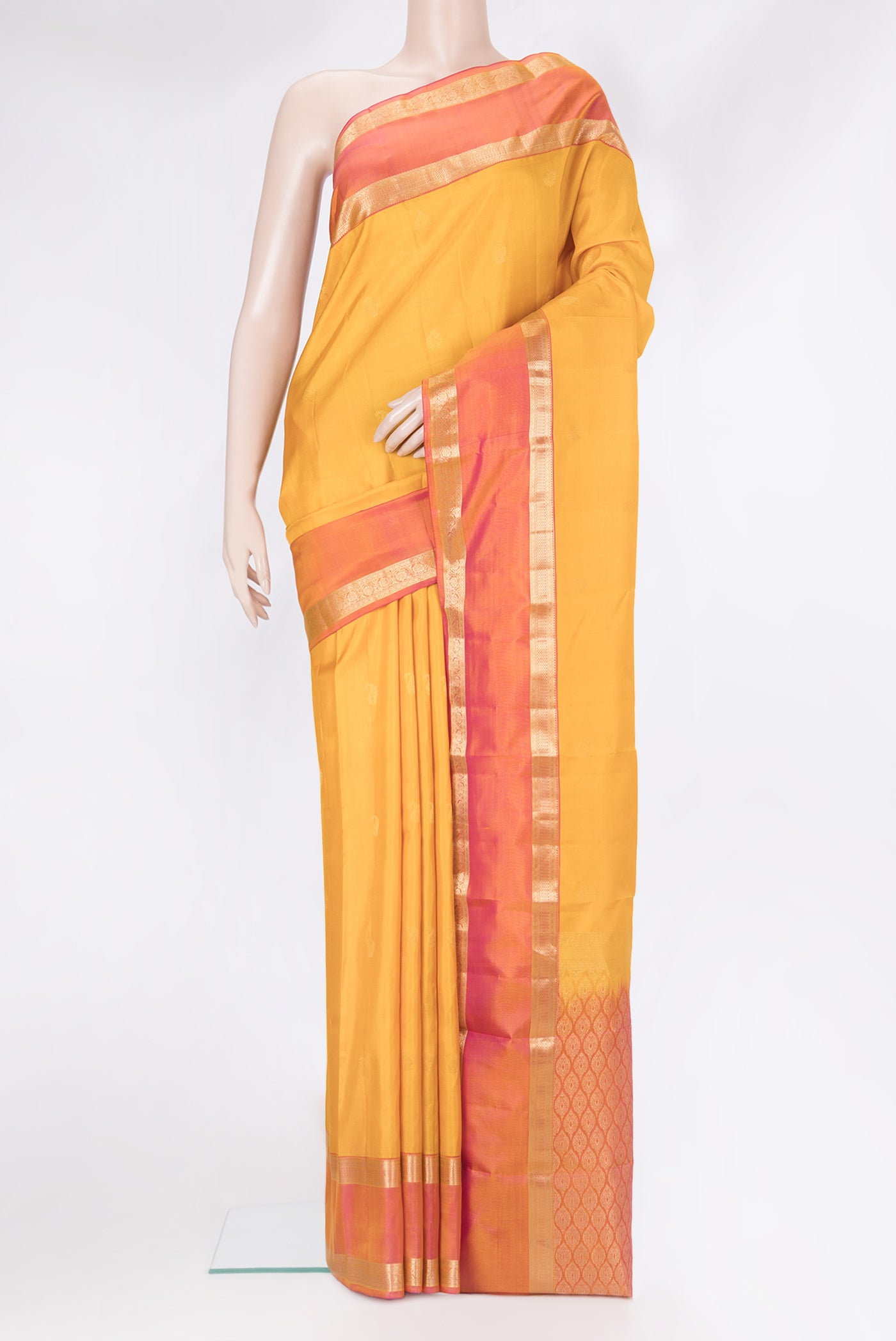 Yellow Kanchipuram Silk Saree with Zari Butta on the body and Zari Border.  displayed on a mannequin