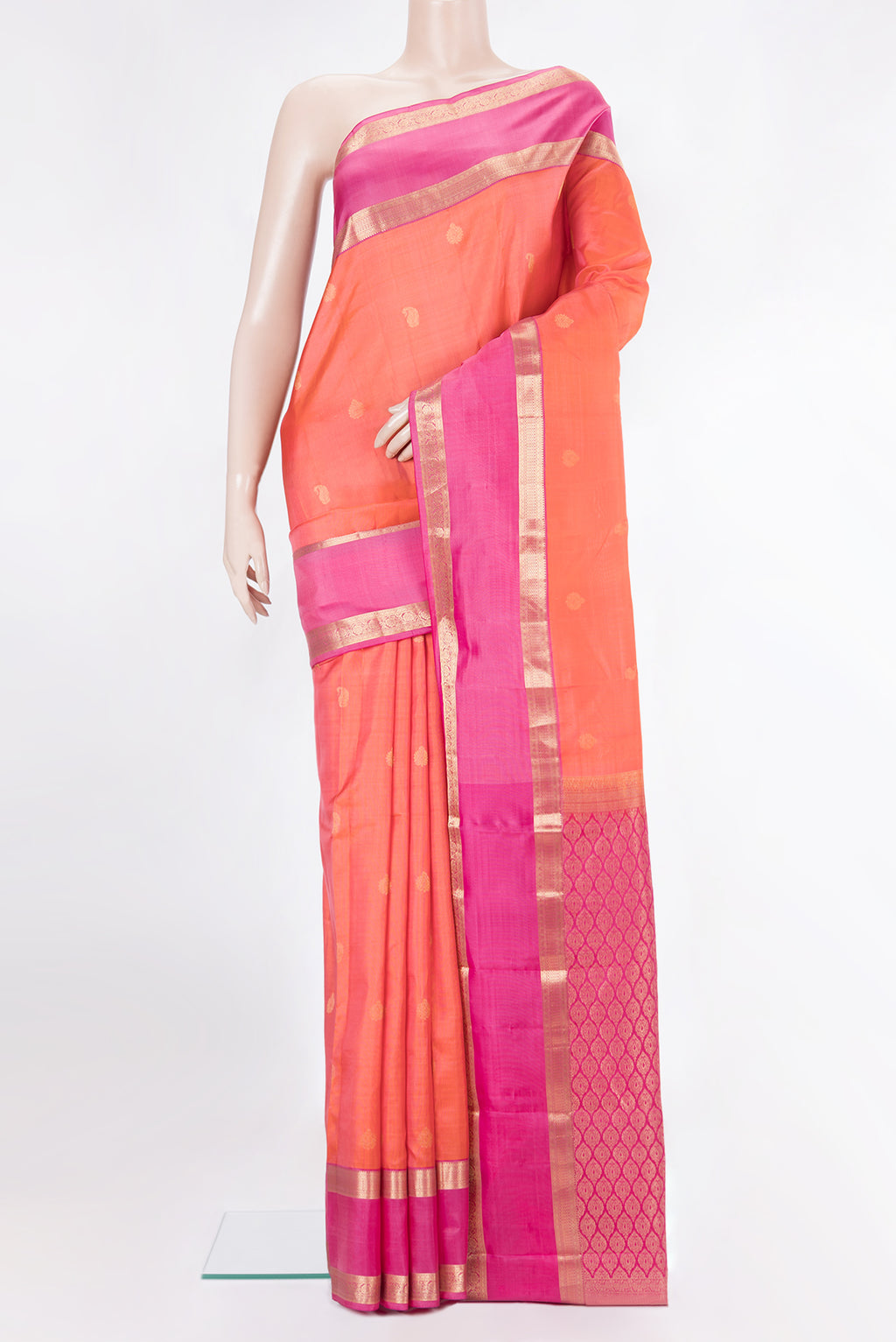 Pure Silk Orange Kanchipuram Saree with Zari Butta on the body and Zari Border.  displayed on a mannequin