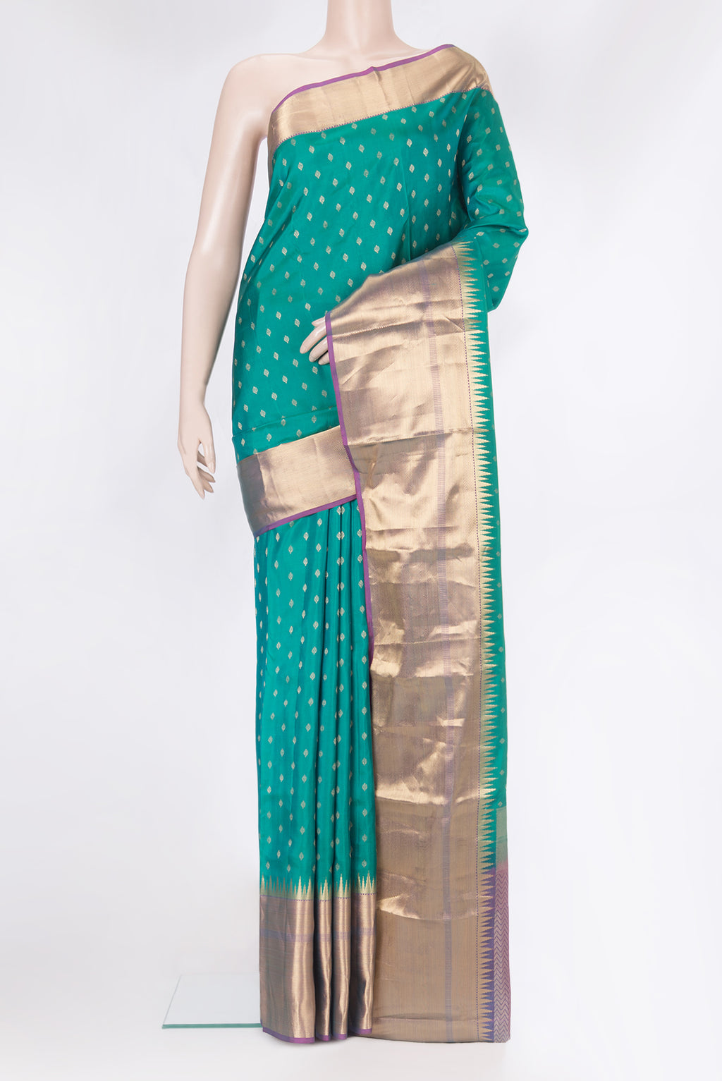 Green Kanchipuram Silk Saree with Zari Butta on the body and Zari Border.  displayed on a mannequin