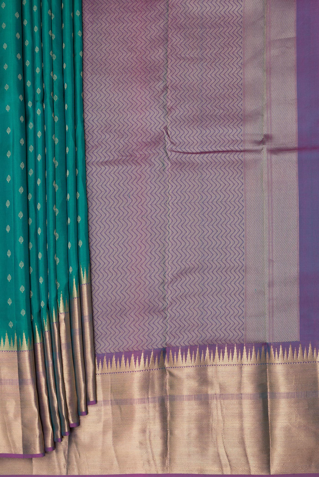 Pleats and pallu of Green Kanchipuram Silk Saree with Zari Butta on the body and Zari Border. 
