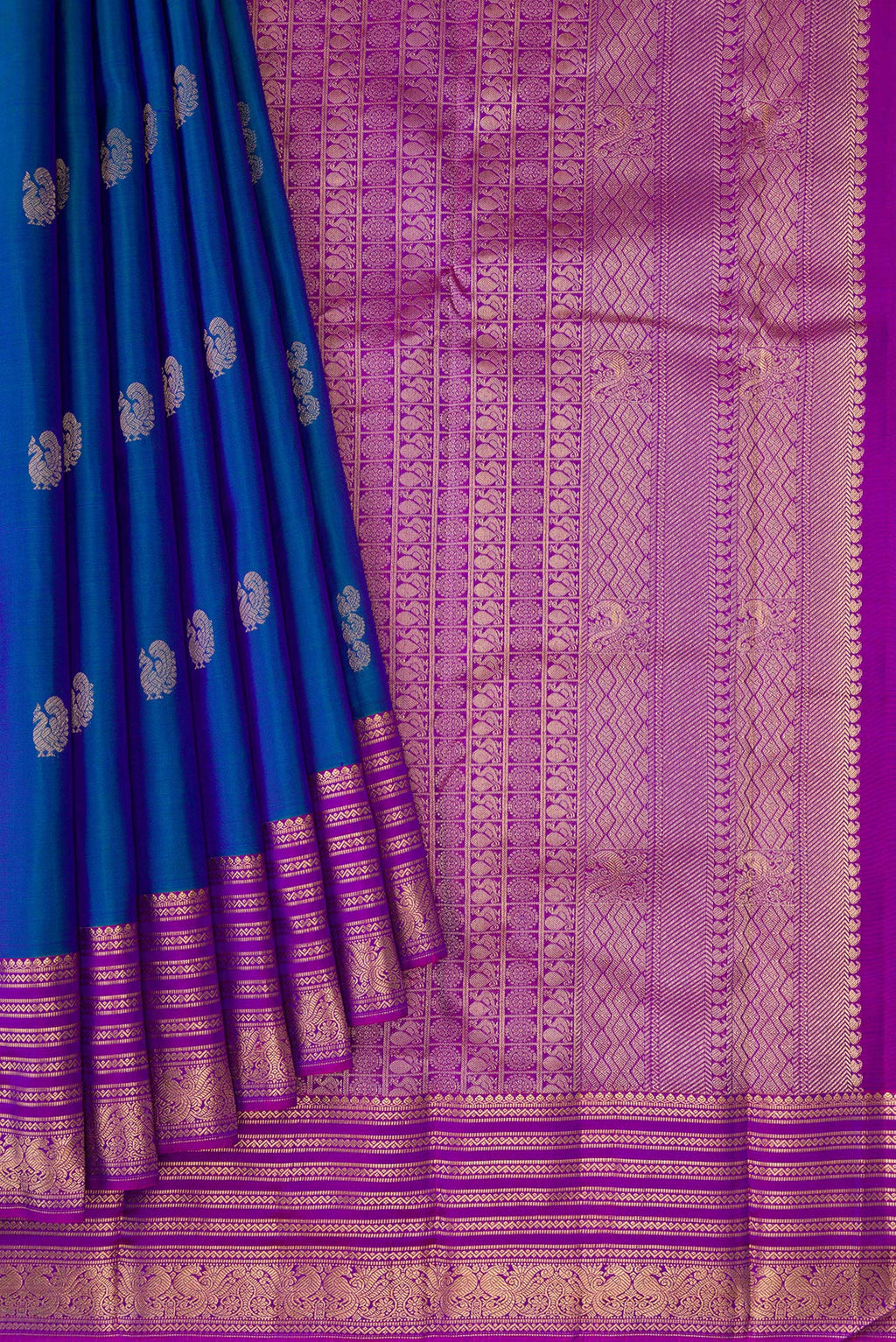 Pleats and pallu of Peacock Blue Dual Tone Kanchipuram Silk Saree with Zari Butta on the body and Zari Border. 